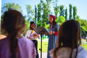l'illustratrice Nicoletta Bertelle legge il libro multicodice "Il tesoro del labirinto incantato" ai bambini presenti all'inagurazione del parco